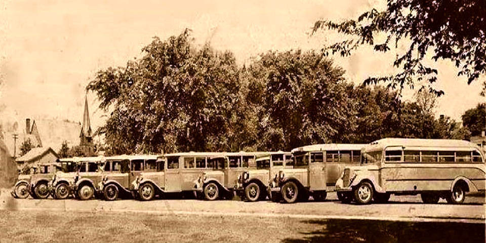 School Buses next to Presbyterian Church on Main St across from the Deer Park on left side of the photo Newark Delaware circa 1920s